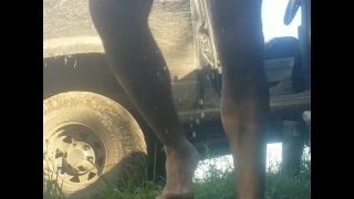 Grown Man Pees Himself In Shorts And Bare Feet Outdoors In The Grass By The Dirty Truck