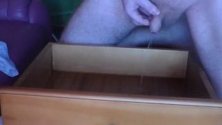 John Is Pissing Into The Bookcase Drawer